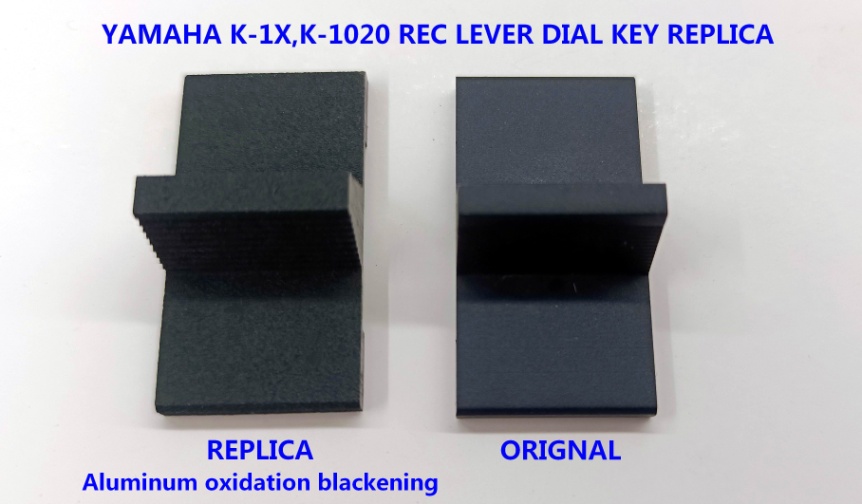 Replica Yamaha rec lever dial key next to the original — aluminum oxidation blackening